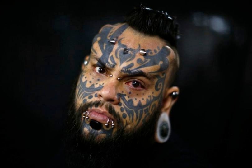 A body modification and tattoo artist poses for a portrait at Caracas's International Tattoo Festival